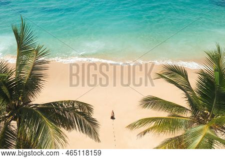 Aerial Drone View Beautiful Tropical Beach With White Sand Palm Trees And Clear Water And Woman Mode