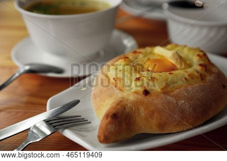 Fresh Delicious Adjarian Khachapuri With Cheese And Egg On Wooden Table, Closeup