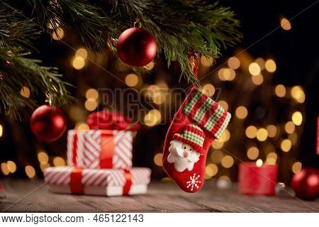 Red Christmas Stocking On A Blurry Festive Background.