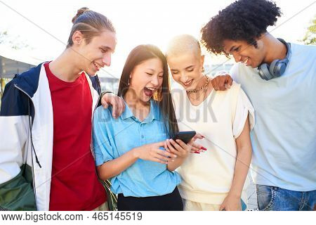Gen Z Young Students Using Smartphone And Social Networks Together. Multiracial People Having Fun To