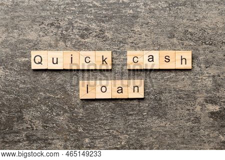 Quick Cash Loan Word Written On Wood Block. Quick Cash Loan Text On Table, Concept.