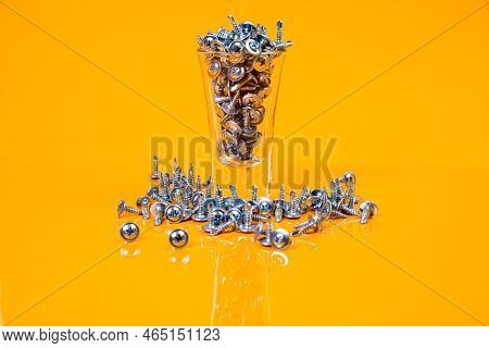 Many Metal Self-tapping Screws Made Of Steel In A Glass, In Bucket Jar. Self-tapping Screw For Metal
