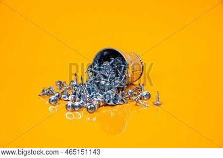 Many Metal Self-tapping Screws Made Of Steel In A Glass, In Bucket Jar. Self-tapping Screw For Metal