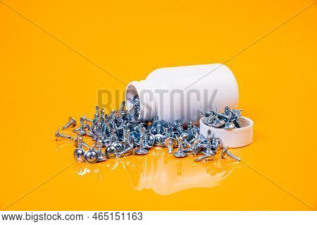 Many Metal Self-tapping Screws Made Of Steel In A Glass, In Bucket Jar. Self-tapping Screw For Metal