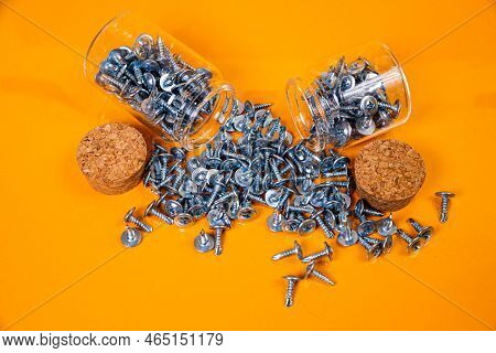 Many Metal Self-tapping Screws Made Of Steel In A Glass, In Bucket Jar. Self-tapping Screw For Metal