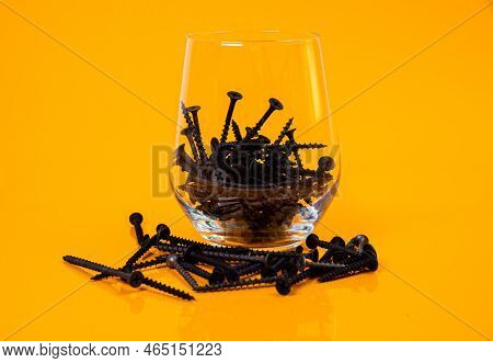 Many Metal Self-tapping Screws Made Of Steel In A Glass, In Bucket Jar. Self-tapping Screw For Metal