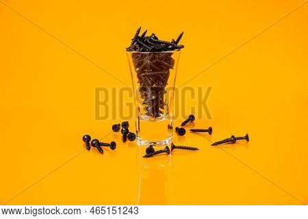Many Metal Self-tapping Screws Made Of Steel In A Glass, In Bucket Jar. Self-tapping Screw For Metal