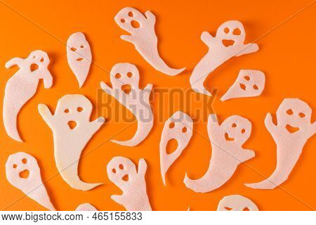 White Ghosts Kids Craft For Halloween. Wrapping Paper Ghost On Orange Background Top View. A Scary A
