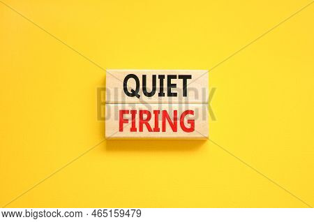 Quiet Firing Symbol. Concept Words Quiet Firing On Wooden Blocks. Beautiful Yellow Table Yellow Back
