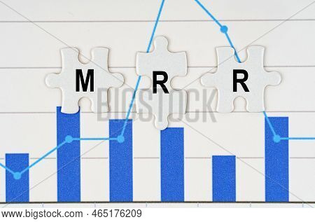 Business Concept. On Business Reports - Diagrams Are Puzzles With The Inscription - Mrr