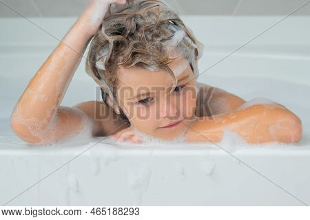 Kids Shampoo. Child In The Bath With Bubbles. Happy Child Enjoying Bath Time. Little Boy Smiling In 