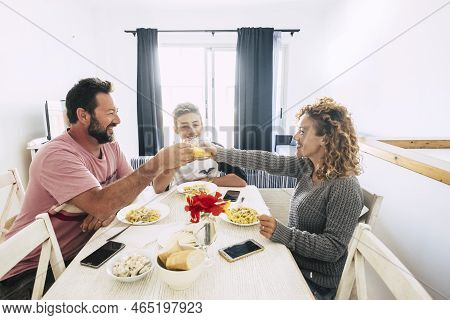 Happy People Caucasian Family With Mom Dad And Son Eatiign Together At Home In A White Bright Room -