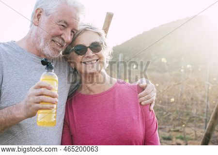 Happy Cheerful Aged Senior Couple Smile And Enjoy Together Forever Life In Outdoor Country Side With