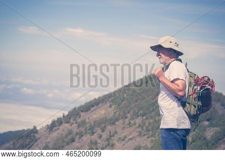 Retired Lifestyle Mature Man With Backpack Traveling And Enjoying The Outdoor Leisure Activity On Th