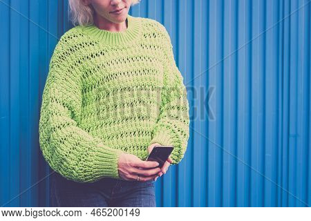 Close Up Technology Cellular Phone Concept With Non Recognizable Girl Using And Messaging On The Dev