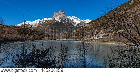 Lanuza Reservoir (huesca), Frozen Water And First Snow In The Mountains.