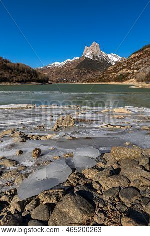 Lanuza Reservoir (huesca), Frozen Water And First Snow In The Mountains.