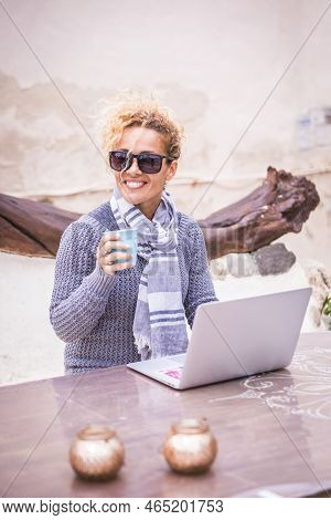 Digital Nomad Concept Withfree. Caucasian Adult Beautiful  Woman Working Outdoor On A Table With Lap