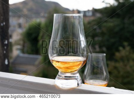 Glass Of Single Malt Scotch Whisky Served On Old Window Sill In Scottisch House With View On Old Par