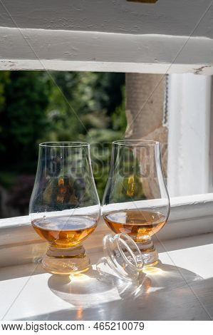 Two Glasses Of Single Malt Scotch Whisky Served On Old Window Sill In Scottisch House With View On O