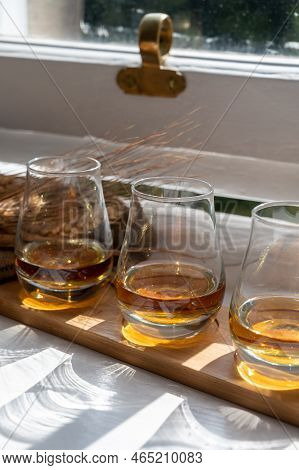 Flight Of Single Malt Scotch Whisky Served On Old Wooden Window Sill In Scottisch House In Edinburgh