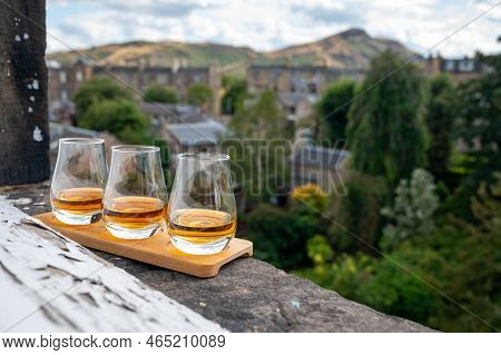 Flight Of Single Malt Scotch Whisky Served On Old Window Sill In Scottisch House With View On Old Pa
