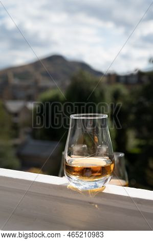 Glass Of Single Malt Scotch Whisky Served On Old White Window Sill In Scottisch House With View On O