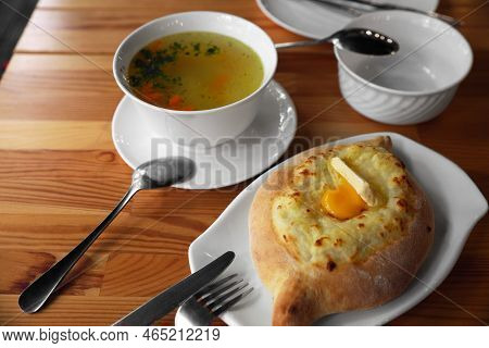 Fresh Delicious Adjarian Khachapuri With Cheese And Egg On Wooden Table