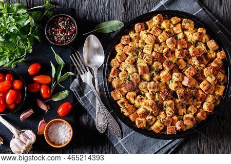 Turkey Pot Pie With Stuffing Crust In Baking Dish On Dark Wood Table With Herbs And Spices On Stone 