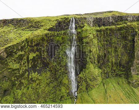 Moss Covered Rock Wall And Drifandi Waterfall - Iceland