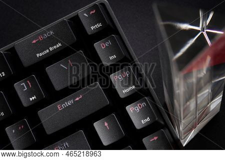 Fragment Of A Trendy Mechanical Computer Keyboard And A Glass Prism On A Black Background. Copy Spac