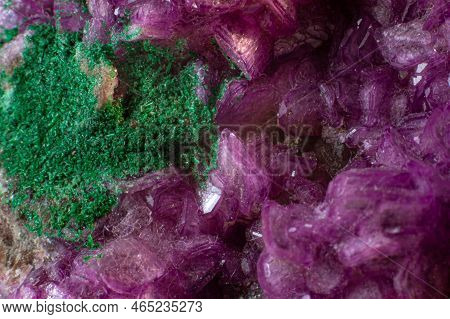 Cobalto calcite with malachite crystal macro on a black surface