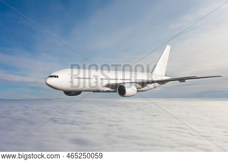 White Wide Body Passenger Jet Plane Fly In The Air Above The Clouds