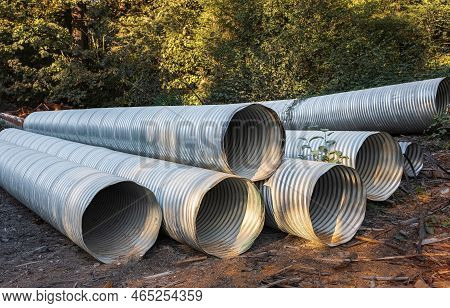 Stormwater Pipes. Large Corrugated Metal Culvert Pipes In Field. Flexible Corrugated Aluminum Tube, 