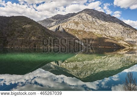 Picturesque Reservoir And Mountain Landscape In Riano. Mirror Effect. Spain