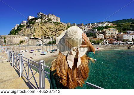 Holidays In Calabria. Rear View Of Beautiful Woman Looking The Fortress And Village Of Pizzo In Cala
