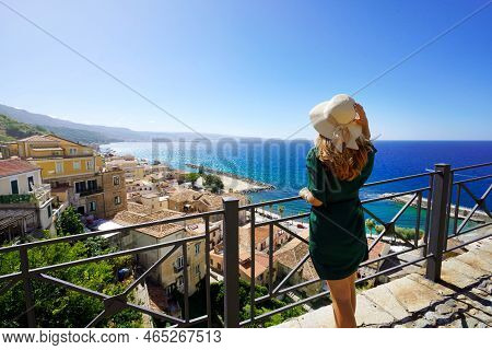 Holidays In Italy. Tourist Woman With Straw Hat Enjoying View Of Pizzo Village From Terrace In Calab