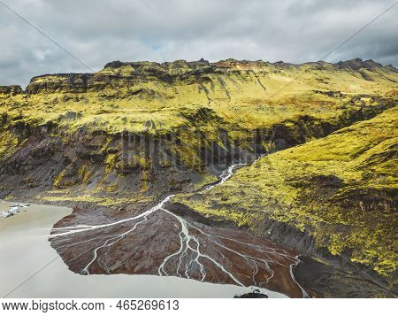 Glacier River Flowing Into The Sea - Iceland Aerial View