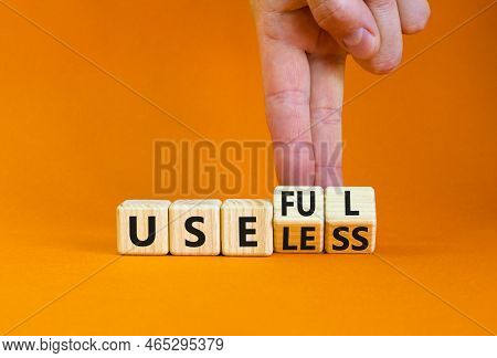 Useful Or Useless Symbol. Concept Words Useful Or Useless On Wooden Cubes. Businessman Hand. Beautif