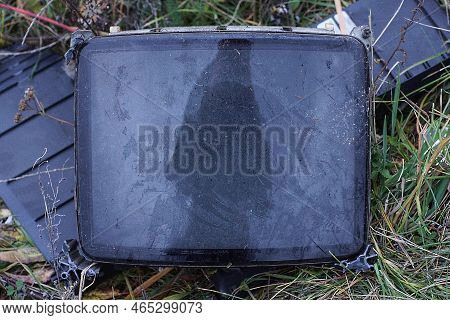 One Old Gray Dirty Glass Kinescope From The Tv Lies On The Green Grass On The Street