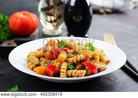 Vegetable Pasta Fusilli Corti Bucati With Eggplant, Sweet Pepper And Chicken In White Plate On Dark 