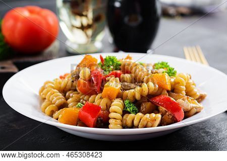 Vegetable Pasta Fusilli Corti Bucati With Eggplant, Sweet Pepper And Chicken In White Plate On Dark 
