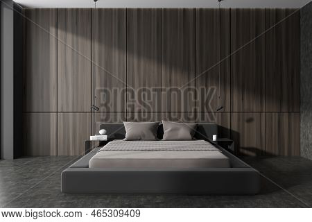 Dark Wooden Bedroom Interior Bed And Nightstand With Decor, Grey Concrete Floor. Sleeping Area With 