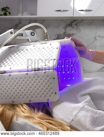 Young Woman Having Photodynamic Therapy In Beauty Salon