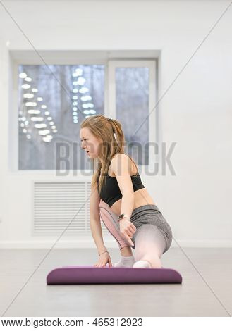 Woman Fitness Trainer Showing How To Stretch Legs On A Mat. Fitness Club Intructor. Young Slim Cauca