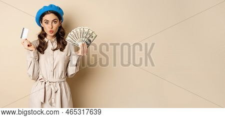 Microcredit And Money Concept. Young Stylish Woman Showing Credit Card And Dollars Cash, Smiling Hap
