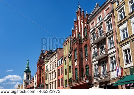 The Belfry Of A Church And Facades Of Historic Tenement Houses In Torun, Poland