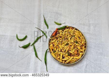 Top Views Of Mix Chanachur With Green Chilli Over White Background Named Bombey Mix. Popular Tea-tim