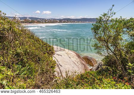 Beach View In Middle Of Vegetation And Rocks