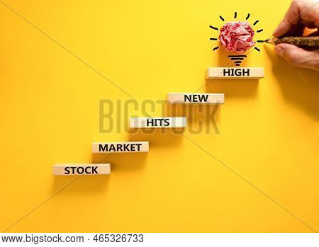 Stock Market Hits New High Symbol. Concept Words Stock Market Hits New High On Wooden Blocks On A Be